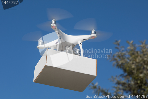 Image of Unmanned Aircraft System (UAS) Quadcopter Drone Carrying Blank P