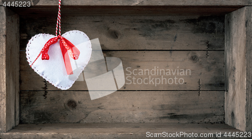 Image of felt heart on a wooden background