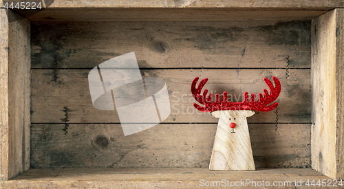 Image of Christmas symbols decoration wooden reindeer in a wooden box