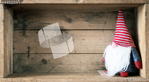 Image of Christmas decoration with a gnome in a wooden box background