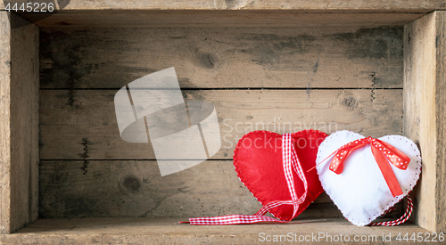 Image of felt hearts on a wooden background