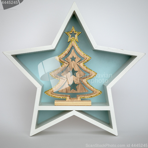 Image of Christmas decoration white star with fir tree inside