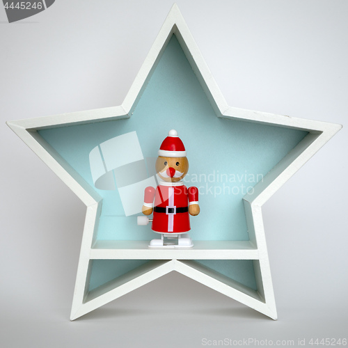 Image of Christmas decoration white star with funny Santa Claus figure in