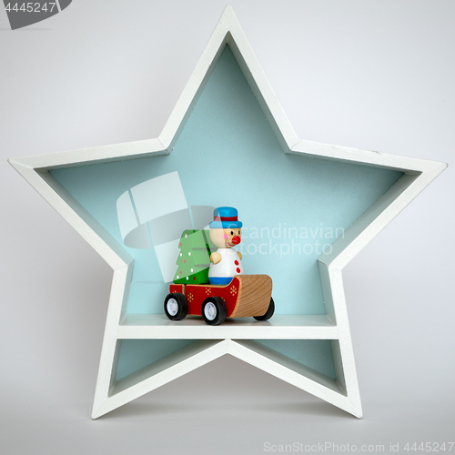 Image of Christmas decoration white star with funny figure inside