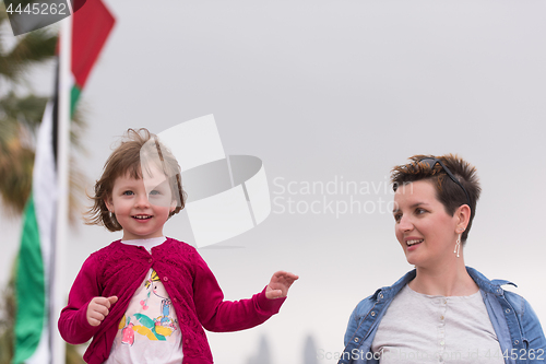 Image of mother and cute little girl on the promenade