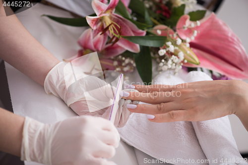 Image of Woman hands receiving a manicure