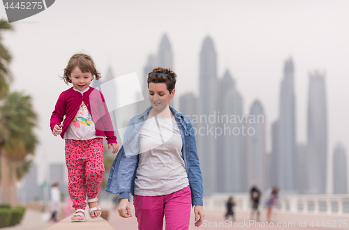 Image of mother and cute little girl on the promenade