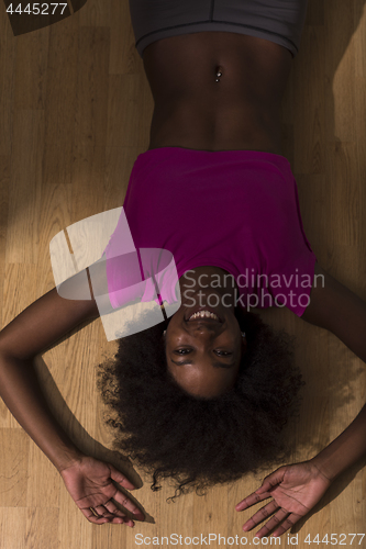 Image of woman  relaxing after pilates workout