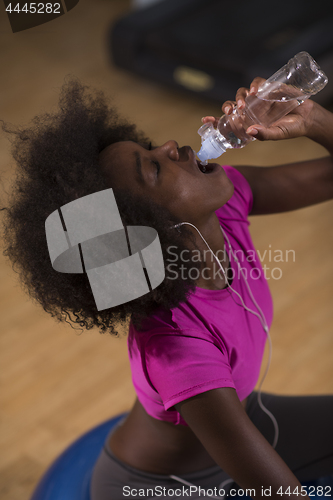 Image of young afro american woman in gym have pilates workout break