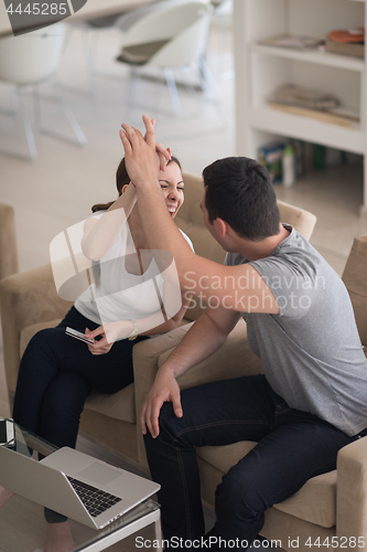 Image of happy young couple buying online