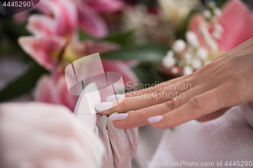 Image of Woman hands receiving a manicure