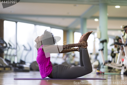 Image of african american woman exercise yoga in gym