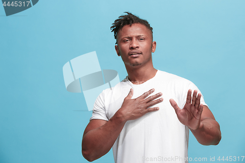 Image of Young serious thoughtful Afro-American businessman. Doubt concept.