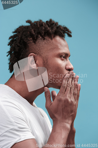 Image of Portrait of attractive Afro-American man with air kiss isolated over blue background