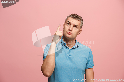 Image of Young serious thoughtful businessman. Doubt concept.