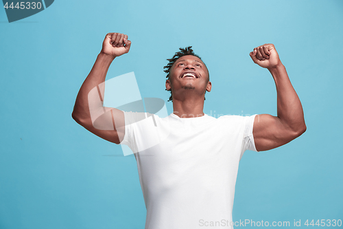 Image of Winning success afro-american man happy ecstatic celebrating being a winner. Dynamic energetic image of male model