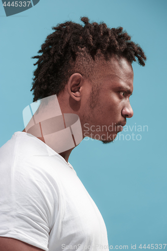 Image of The young emotional angry afro man on blue studio background