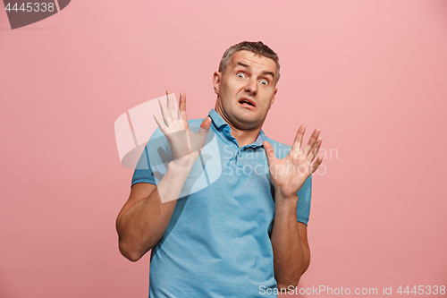 Image of Portrait of the scared man on pink