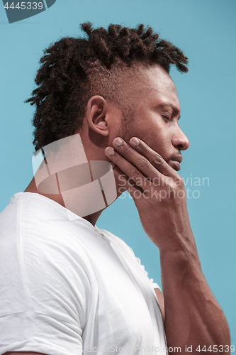 Image of Young Afro-American man is having toothache.