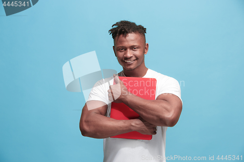 Image of Afro-American Businessman hugging laptop