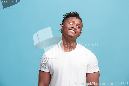 Image of The squint eyed afro-american man with weird expression isolated on blue