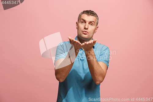 Image of Portrait of attractive man with kiss isolated over pink background