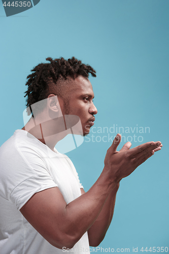 Image of Portrait of attractive Afro-American man with air kiss isolated over blue background