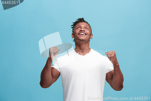 Image of Winning success afro-american man happy ecstatic celebrating being a winner. Dynamic energetic image of male model