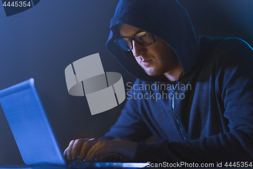 Image of hacker using laptop computer for cyber attack