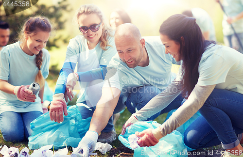 Image of volunteers with garbage bags cleaning park area