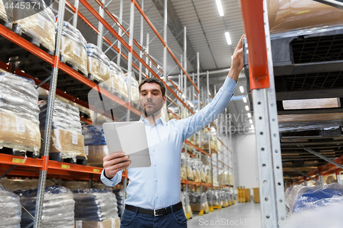 Image of businessman with tablet pc at warehouse