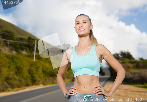 Image of happy young woman doing sports outdoors