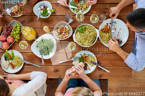 Image of group of people eating at table with food