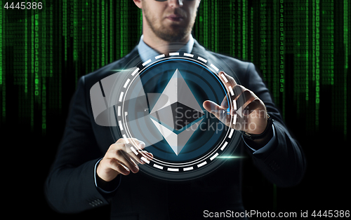 Image of businessman hand with ethereum over binary code