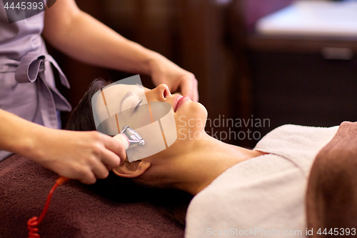 Image of woman having hydradermie facial treatment in spa