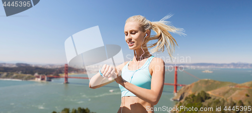 Image of woman with fitness tracker over golden gate bridge