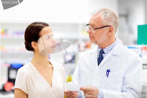 Image of apothecary and woman with prescription at pharmacy