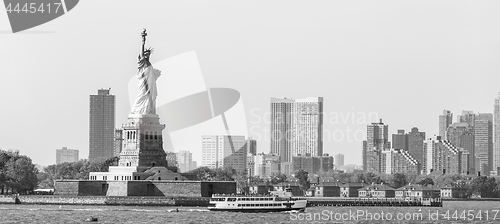 Image of Statue of Liberty with Liberty State Park and Jersey City skyscrapers in background, USA