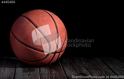 Image of Basketball ball on a wooden floor