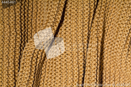 Image of Yellow wool knitted scarf closeup.