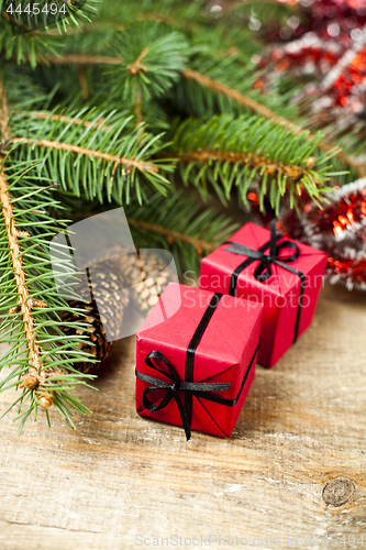 Image of Christmas fir tree with pinecones and decorative boxes.