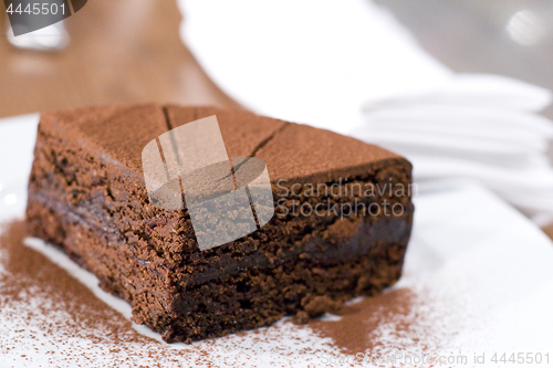 Image of Piece of chocolate cake on white plate.