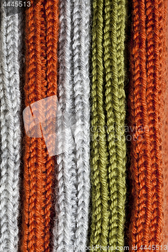 Image of Orange, green and grey wool knitted texture.