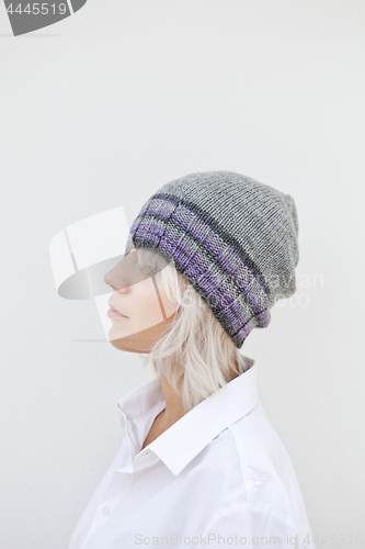 Image of Beautiful young woman in warm grey beanie.