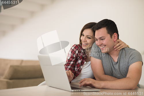 Image of happy young couple buying online