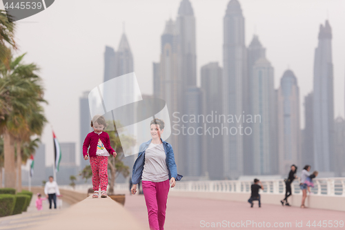 Image of mother and cute little girl on the promenade