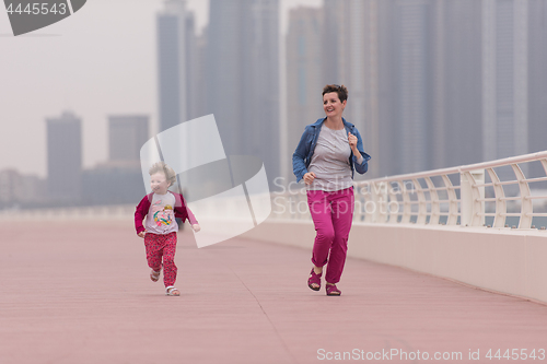 Image of mother and cute little girl on the promenade