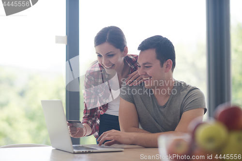 Image of happy young couple buying online