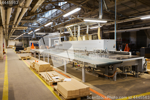 Image of chipboards on conveyer at furniture factory