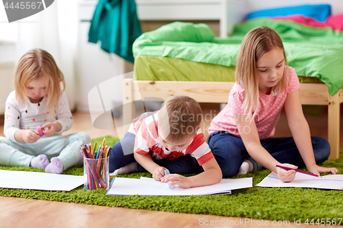 Image of happy kids drawing at home